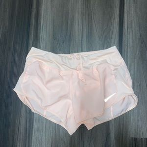 Light pink Nike running shorts with adjustable strings